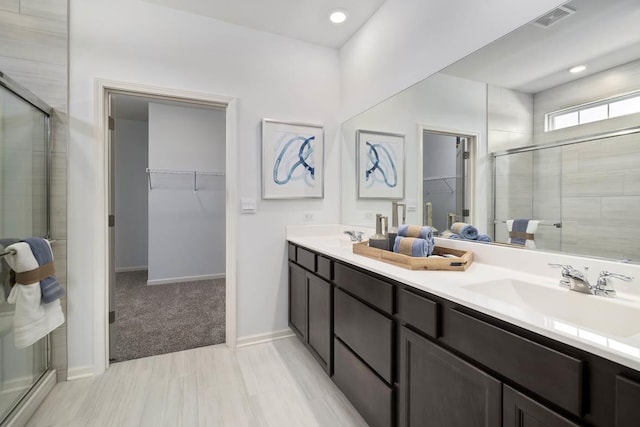 14712 S Azalia Cir, Plainfield, IL 60544 - full bathroom featuring a walk in closet, a shower stall, double vanity, and baseboards
