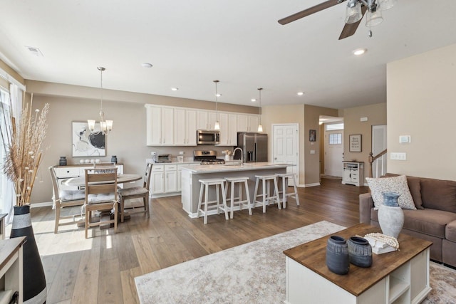 12654 S Talbot Cir, Plainfield, IL 60585 - living area featuring a ceiling fan, light wood finished floors, recessed lighting, a chandelier, and baseboards