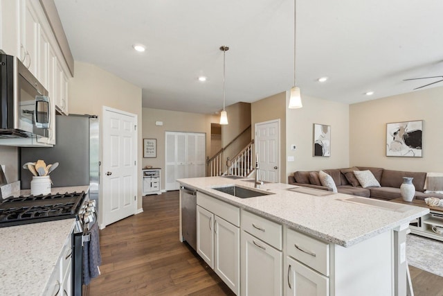 12654 S Talbot Cir, Plainfield, IL 60585 - kitchen with stainless steel appliances, white cabinetry, dark wood finished floors, light stone counters, and hanging light fixtures
