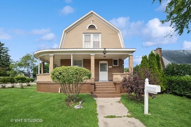558 N Crystal St, Elgin, IL 60123 - dutch colonial featuring a gambrel roof, a porch, and brick siding