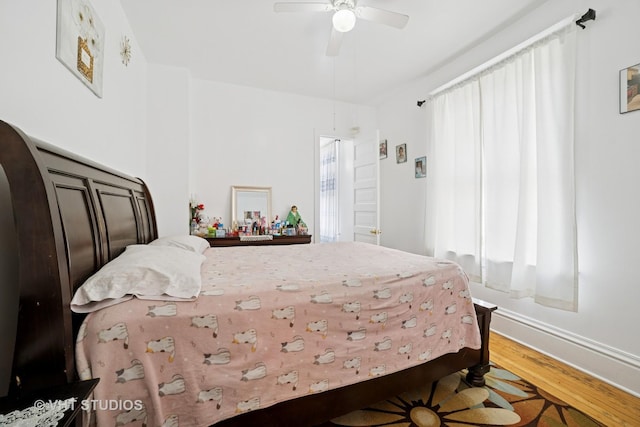 558 N Crystal St, Elgin, IL 60123 - bedroom featuring wood finished floors, arched walkways, and a ceiling fan