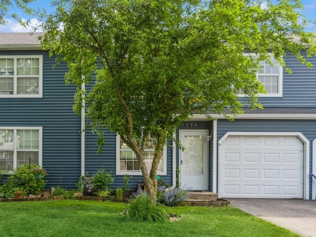 1994 Countryside Ln, Round Lake Beach, IL 60073 - obstructed view of property featuring a garage, a front lawn, and driveway
