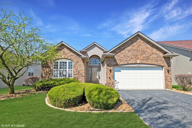 17100 Como Ave, Lockport, IL 60441 - view of front of house with brick siding, asphalt driveway, a garage, and a front yard