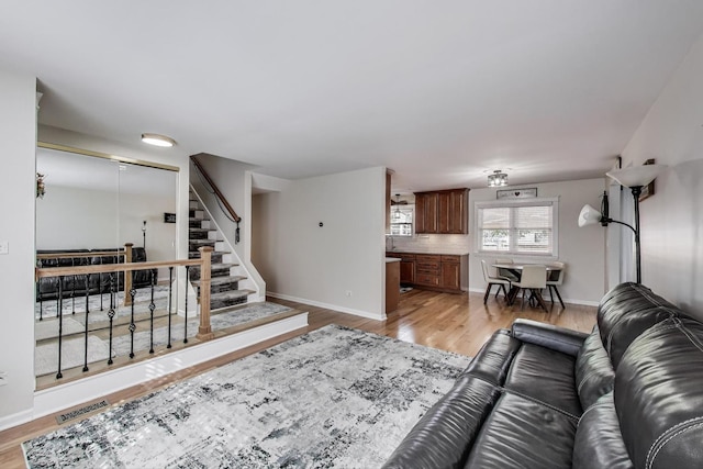 6 Plover Ct, Woodridge, IL 60517 - living room with light wood-style floors, baseboards, and stairs