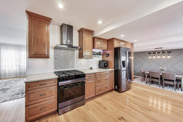 6 Plover Ct, Woodridge, IL 60517 - kitchen with appliances with stainless steel finishes, wall chimney exhaust hood, light wood finished floors, and tasteful backsplash