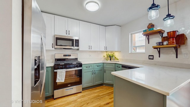 3649 W Cornelia Ave Unit C, Chicago, IL 60618 - kitchen featuring stainless steel appliances, green cabinets, open shelves, white cabinets, and light wood-type flooring
