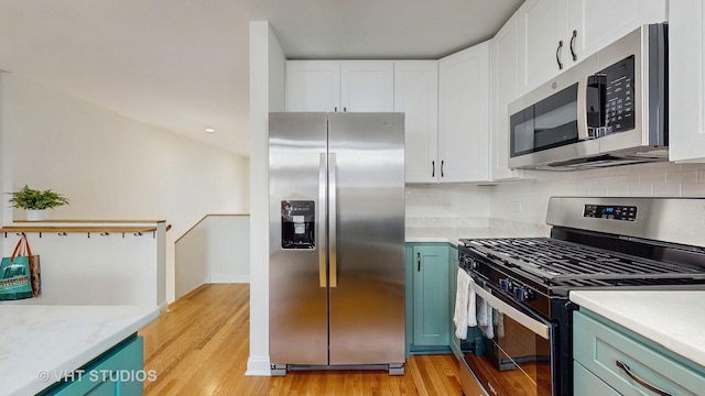 3649 W Cornelia Ave Unit C, Chicago, IL 60618 - kitchen with stainless steel appliances, light countertops, light wood-style flooring, and white cabinets