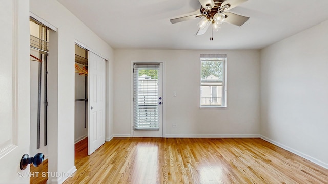 3649 W Cornelia Ave Unit C, Chicago, IL 60618 - unfurnished bedroom featuring light wood finished floors, baseboards, and two closets