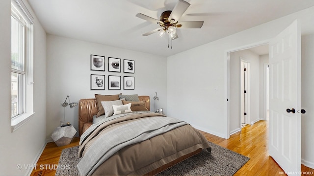 3649 W Cornelia Ave Unit C, Chicago, IL 60618 - bedroom featuring multiple windows, light wood finished floors, and baseboards