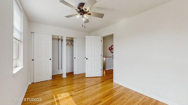 3649 W Cornelia Ave Unit C, Chicago, IL 60618 - unfurnished bedroom with multiple closets, baseboards, light wood-style flooring, and a ceiling fan
