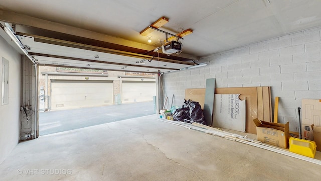 3649 W Cornelia Ave Unit C, Chicago, IL 60618 - garage featuring a garage door opener and concrete block wall