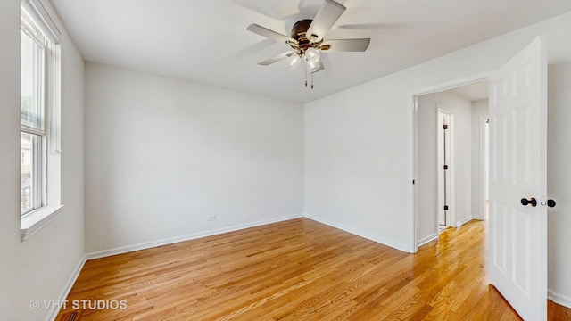 3649 W Cornelia Ave Unit C, Chicago, IL 60618 - spare room featuring healthy amount of natural light, light wood-style floors, a ceiling fan, and baseboards