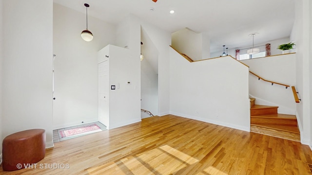 3649 W Cornelia Ave Unit C, Chicago, IL 60618 - unfurnished living room featuring wood finished floors, stairs, and baseboards