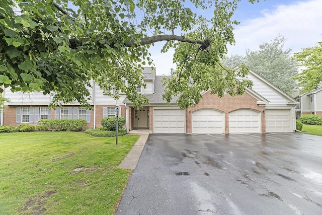 1604 Newburn Ct Unit D1, Wheeling, IL 60090 - view of front of property with brick siding, asphalt driveway, a front yard, and an attached garage