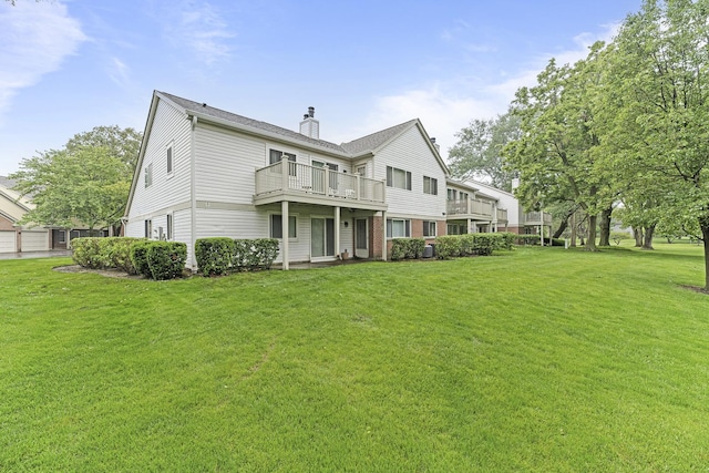 1604 Newburn Ct Unit D1, Wheeling, IL 60090 - back of house with a chimney, a yard, and a balcony