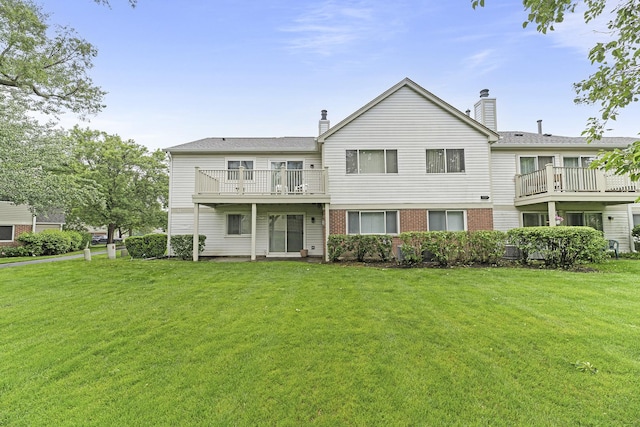 1604 Newburn Ct Unit D1, Wheeling, IL 60090 - back of property featuring a lawn, a chimney, and brick siding