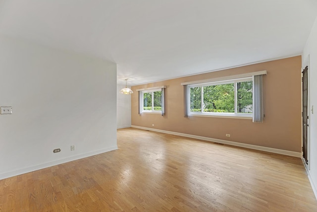 1604 Newburn Ct Unit D1, Wheeling, IL 60090 - empty room featuring a chandelier, baseboards, and light wood finished floors