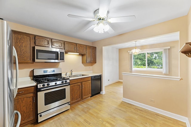 1604 Newburn Ct Unit D1, Wheeling, IL 60090 - kitchen featuring stainless steel appliances, light countertops, a sink, and light wood finished floors