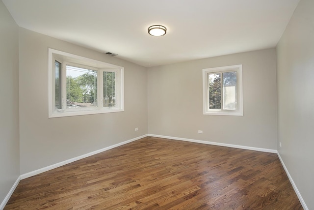 1012 Windsor Rd, Highland Park, IL 60035 - empty room featuring dark wood-type flooring and baseboards