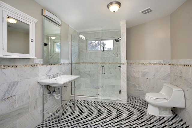 1012 Windsor Rd, Highland Park, IL 60035 - bathroom featuring tile walls, toilet, a shower stall, tile patterned flooring, and wainscoting