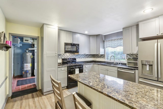 11537 S Neenah Ave, Worth, IL 60482 - kitchen featuring black appliances, gas water heater, a sink, light wood finished floors, and decorative backsplash
