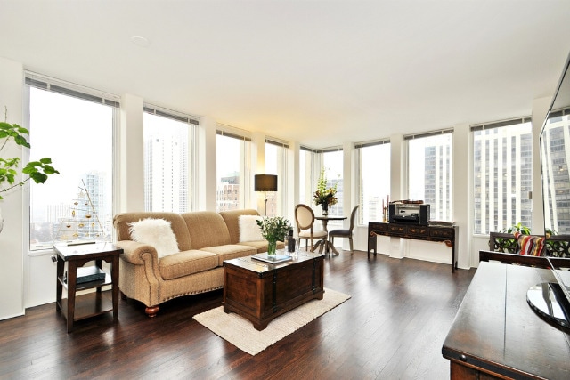 100 E Walton St Unit 22H, Chicago, IL 60611 - living room featuring plenty of natural light and dark wood-style floors