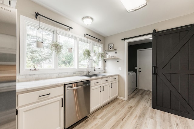 30 Beau Meade Rd, Oswego, IL 60543 - kitchen with appliances with stainless steel finishes, washer and clothes dryer, a sink, white cabinetry, and healthy amount of natural light