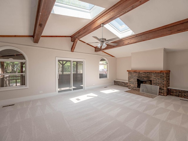 52 S Hawthorne Blvd, Mundelein, IL 60060 - unfurnished living room featuring a skylight, carpet flooring, baseboards, a brick fireplace, and ceiling fan
