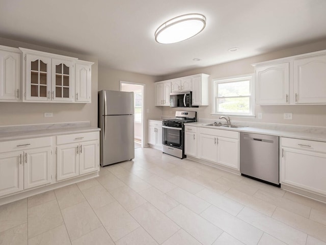 52 S Hawthorne Blvd, Mundelein, IL 60060 - kitchen featuring stainless steel appliances, a sink, white cabinets, and light countertops