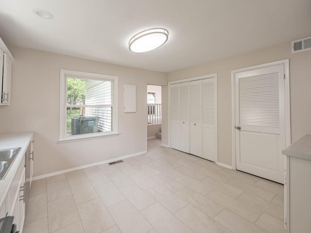 52 S Hawthorne Blvd, Mundelein, IL 60060 - unfurnished bedroom with baseboards, two closets, and a sink