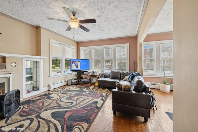 8212 S Bishop St, Chicago, IL 60620 - living area with crown molding, hardwood / wood-style floors, ceiling fan, a textured ceiling, and baseboard heating