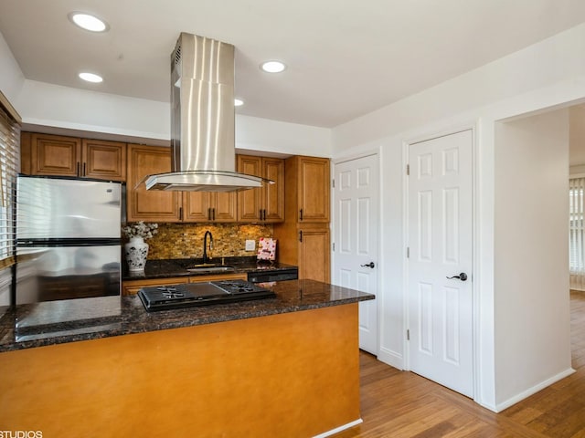 1812 Bristol Walk Unit 1812, Hoffman Estates, IL 60169 - kitchen featuring freestanding refrigerator, island range hood, a sink, black gas cooktop, and brown cabinetry
