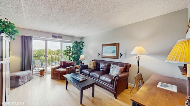 5400 Walnut Ave Unit 201, Downers Grove, IL 60515 - living area with a textured ceiling and light wood-style floors