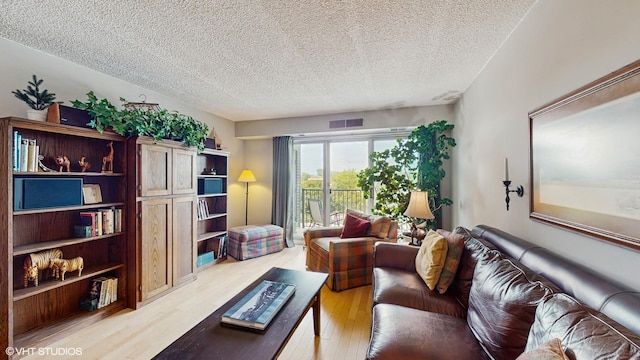 5400 Walnut Ave Unit 201, Downers Grove, IL 60515 - living area with a textured ceiling and light wood-type flooring