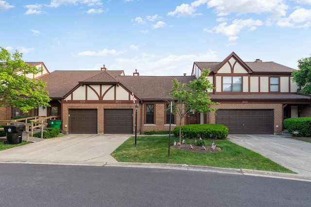 3072 Carlton Ct, Westchester, IL 60154 - tudor house with concrete driveway, brick siding, and stucco siding