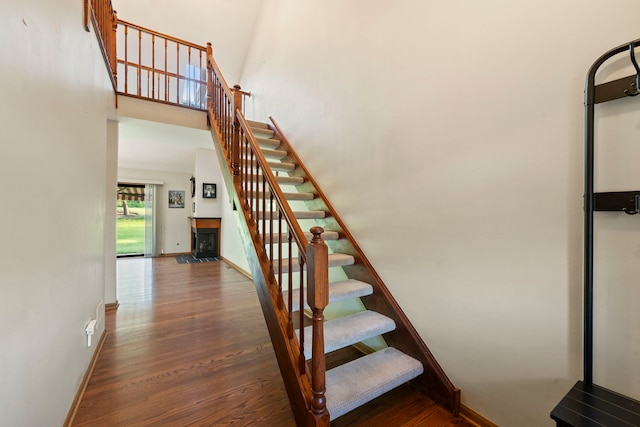 3072 Carlton Ct, Westchester, IL 60154 - staircase with wood finished floors, a fireplace, and a high ceiling