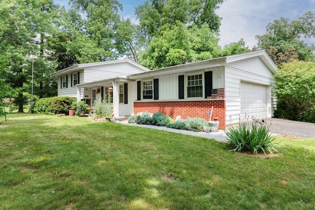 8524 Carriage Hills Rd, Bloomington, IL 61705 - tri-level home featuring a front yard, brick siding, asphalt driveway, a garage, and board and batten siding