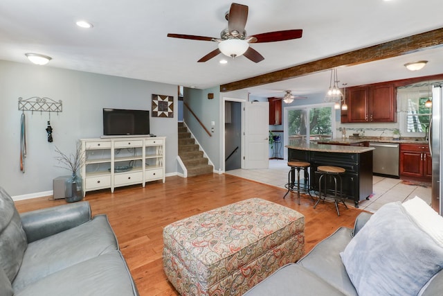 8524 Carriage Hills Rd, Bloomington, IL 61705 - living area with stairway, plenty of natural light, recessed lighting, a ceiling fan, and light wood-style floors