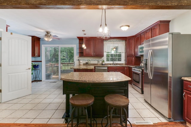 8524 Carriage Hills Rd, Bloomington, IL 61705 - kitchen featuring stainless steel appliances, light tile patterned floors, a center island, and pendant lighting