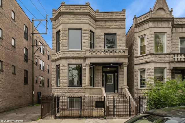 1332 S Lawndale Ave, Chicago, IL 60623 - view of front of house featuring a fenced front yard, a gate, and stone siding