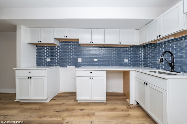 1332 S Lawndale Ave, Chicago, IL 60623 - kitchen featuring light wood-style floors, tasteful backsplash, and white cabinets