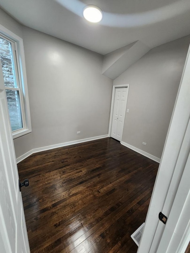 1332 S Lawndale Ave, Chicago, IL 60623 - spare room featuring dark wood-style flooring and vaulted ceiling