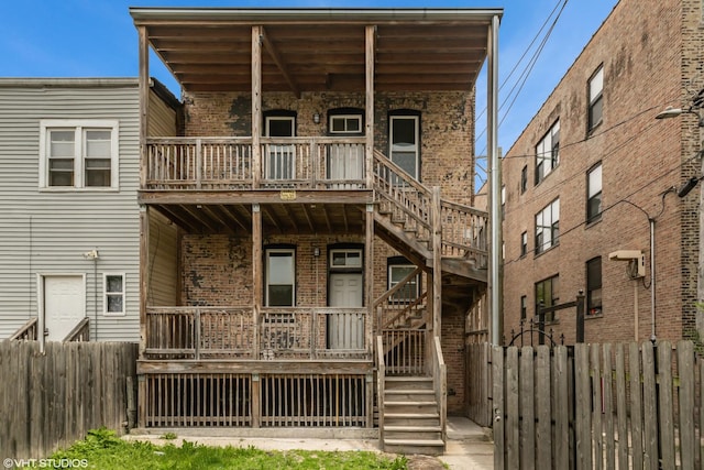 1332 S Lawndale Ave, Chicago, IL 60623 - back of house with brick siding, stairway, and covered porch