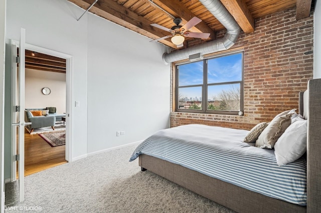 1735 W Diversey Pkwy Unit 402, Chicago, IL 60614 - carpeted bedroom with brick wall, wood ceiling with exposed beams, baseboards, and a ceiling fan