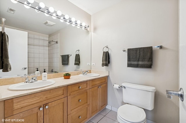 1735 W Diversey Pkwy Unit 402, Chicago, IL 60614 - bathroom with double vanity, toilet, tile patterned flooring, and tiled shower