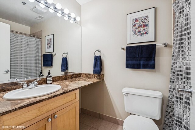 1735 W Diversey Pkwy Unit 402, Chicago, IL 60614 - full bathroom featuring tile patterned flooring, vanity, toilet, and baseboards