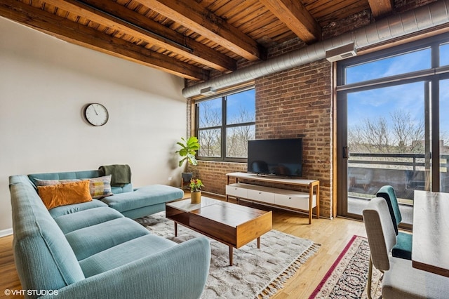 1735 W Diversey Pkwy Unit 402, Chicago, IL 60614 - living area featuring wooden ceiling with exposed beams, plenty of natural light, wood finished floors, and brick wall