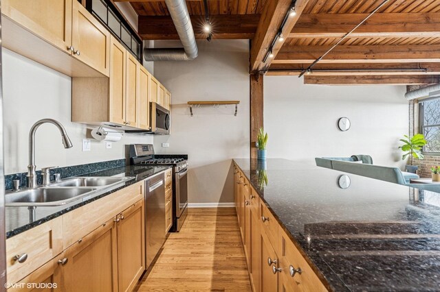 1735 W Diversey Pkwy Unit 402, Chicago, IL 60614 - kitchen with a sink, wood ceiling with exposed beams, stainless steel appliances, light wood-style flooring, and dark stone counters