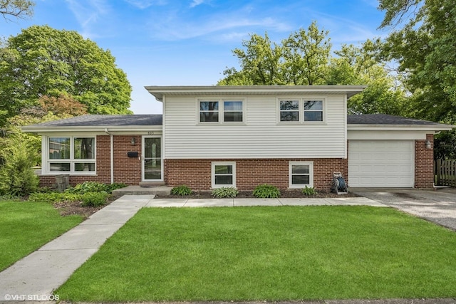 803 W Miner St, Arlington Heights, IL 60005 - tri-level home featuring brick siding, an attached garage, a front lawn, and asphalt driveway