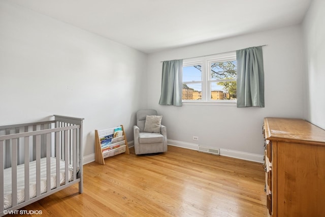 803 W Miner St, Arlington Heights, IL 60005 - bedroom featuring light wood-type flooring, baseboards, and a crib